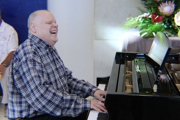 Corky's Gift Corky playing the piano at the cocktail hour of Evening with Envision gala.