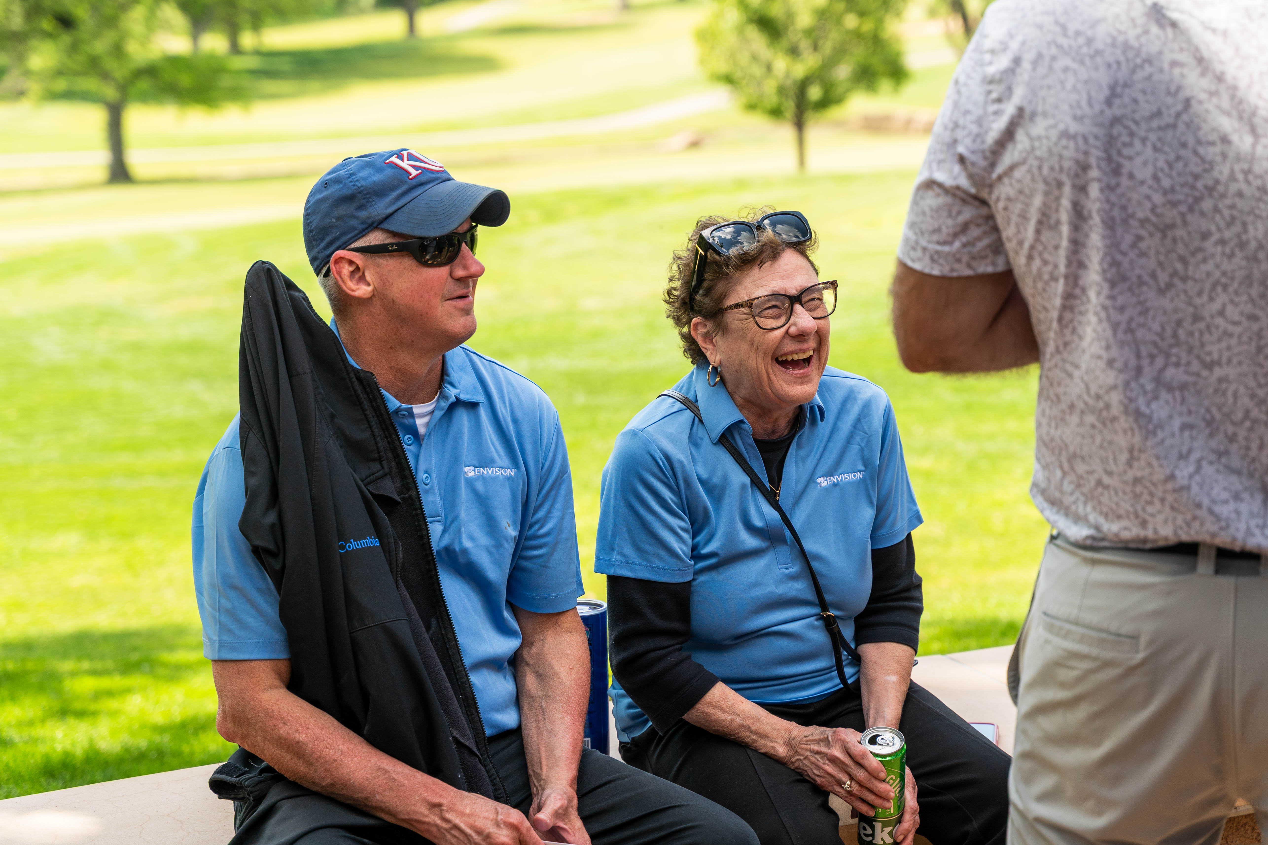 Golf team walking off the green celebrating their shots.
