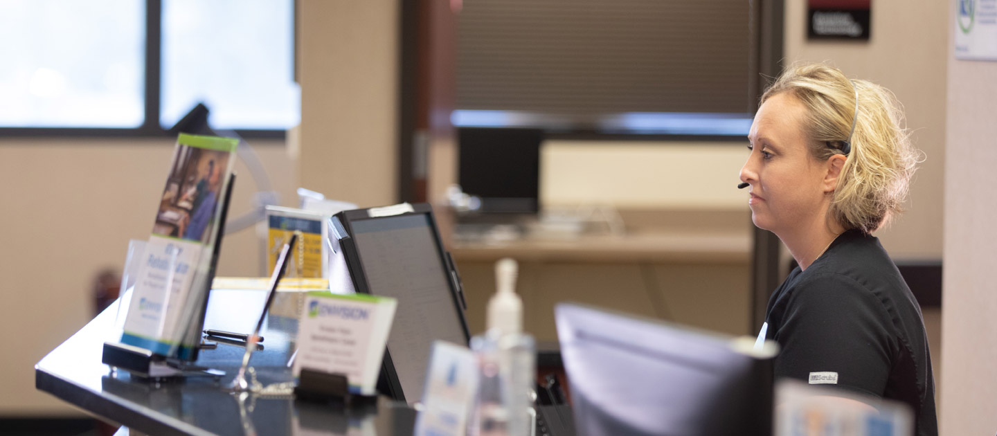 Woman working at the reception desk in the Envision Vision Rehabilitation Center