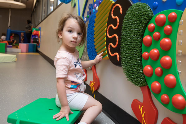 Little girl playing inside the sensory room of the Envision Child Development Center