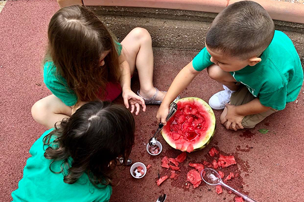 ECDC kids exploring a watermelon
