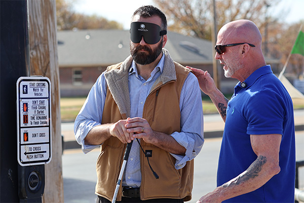 Ray Oddis, Envision Orientation & Mobility Specialist, guides City of Wichita Traffic Engineer Mike 