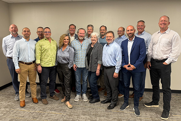 CEOs from Vistage pose for a group photo following a tour of Envision Dallas.