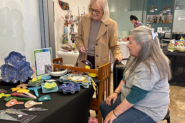 Shopper looks at the variety of gifts offered at the Envision Arts Holiday Market.