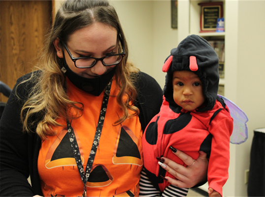 Madison Kester, Early Childhood Educator in the Nursery and a very cute lady bug named Bella. 