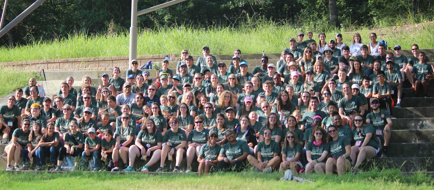Campers of all ages at Heathers Camp sit together for a group picture.