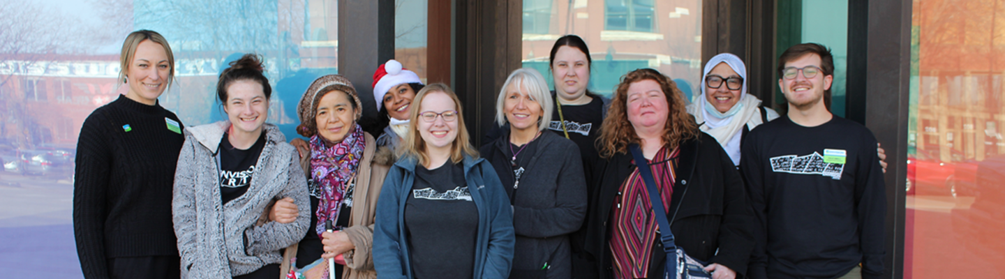 Several Envision Arts students and staff standing in front of the new gallery in downtown Wichita