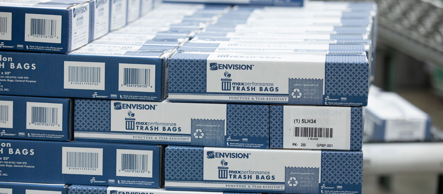 Blue and white boxes filled with max-performance trash bags from Envision.