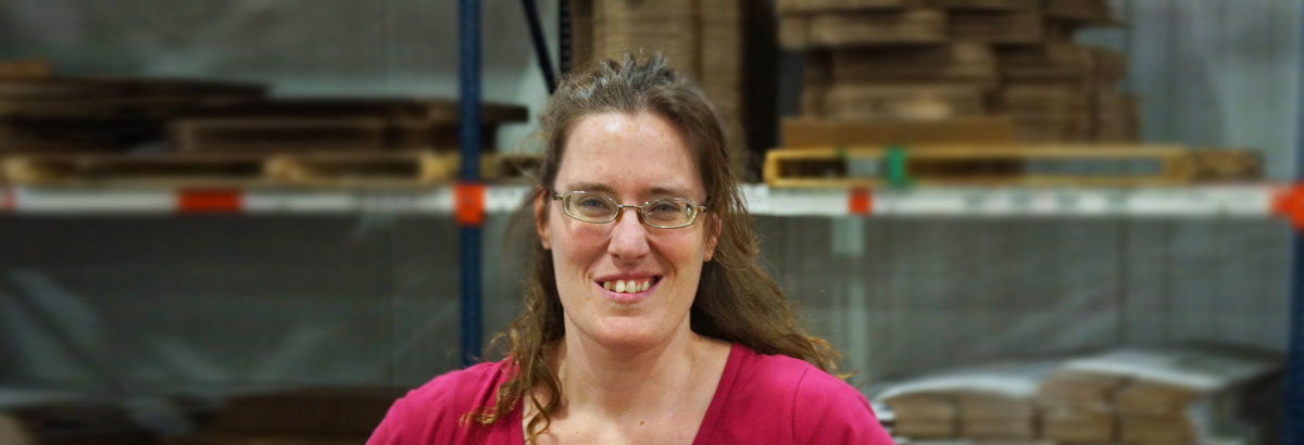Sandra smiling as she does her job at Envision Industries