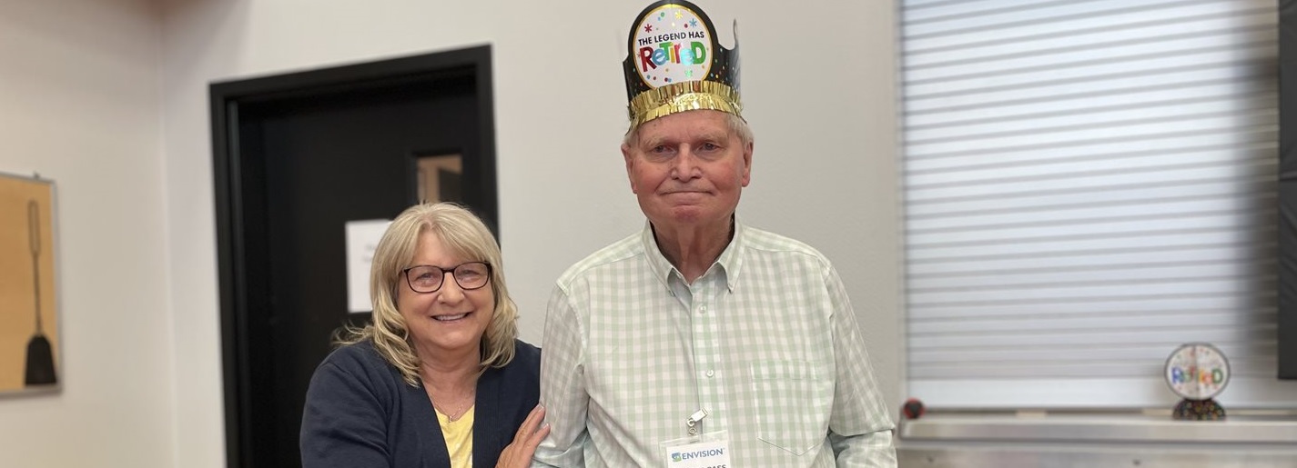 Margie Bradley helps Dale celebrate 21 years of service at Envision