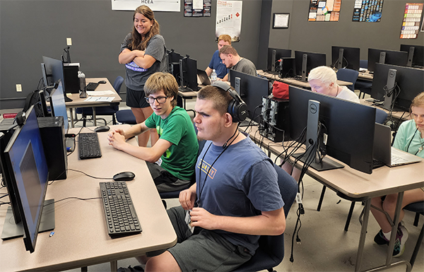 Students who are BVI sitting in a computer lab during an Envision Level Up Cybersecurity class