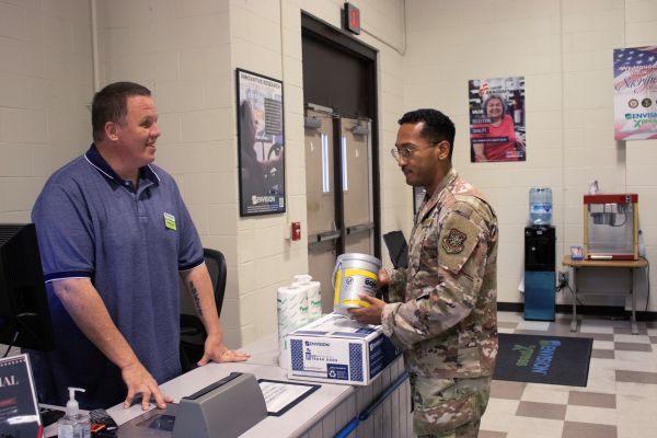 Bryan prepares to check out a soldier’s purchases at the Xpress store.