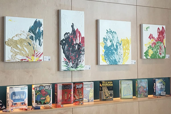 Colorful paintings by Savannah are displayed in the lobby area at the Aloft Hotel.