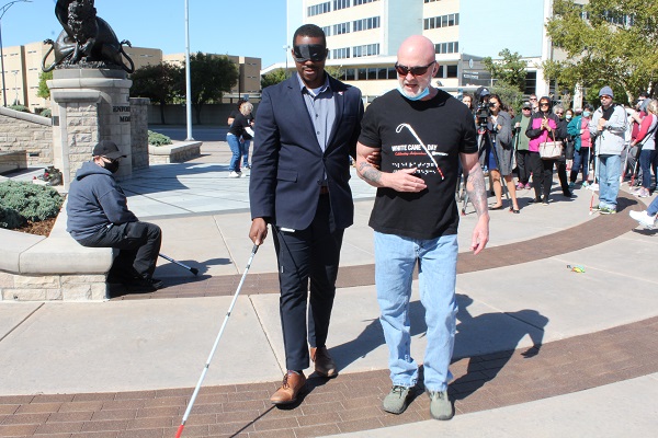 Ray Oddis, Envision orientation and mobility specialist, is guiding Wichita Vice Mayor around with a white cane while blindfolded