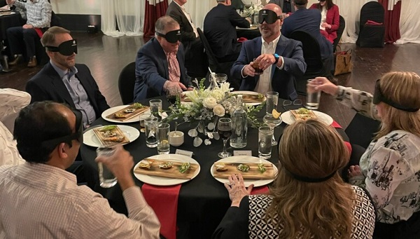 Blind Dinner Experience at Spirit AeroSystems Participants from Spirit AeroSystems wearing blindfolds experience what it is like to dine without s