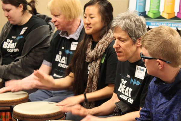 Participants learn to play the drums at the Beat Goes On event.