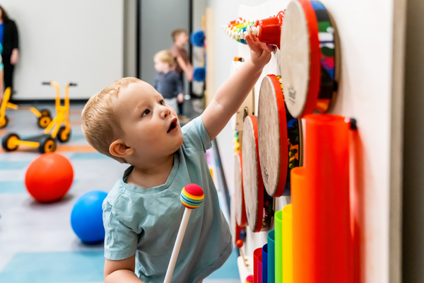 Young student enjoys playing on the sensory board.