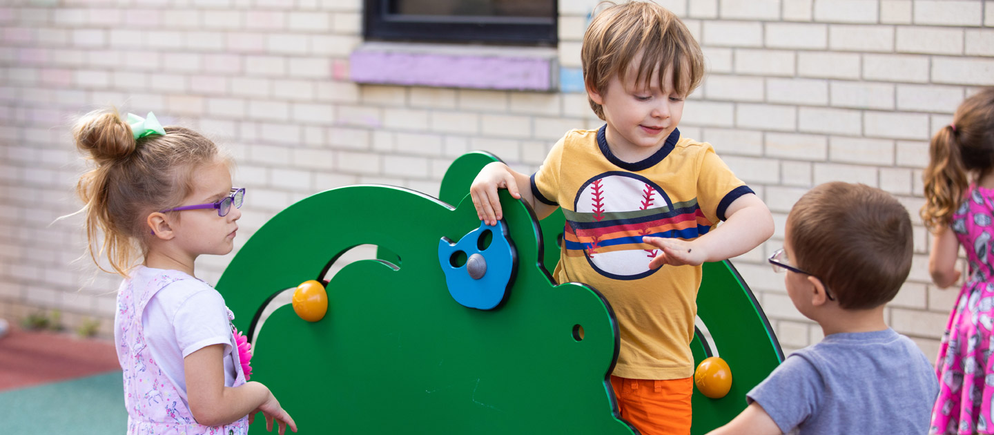 Children playing on the playground at the Early Childhood Development Center at Envision.