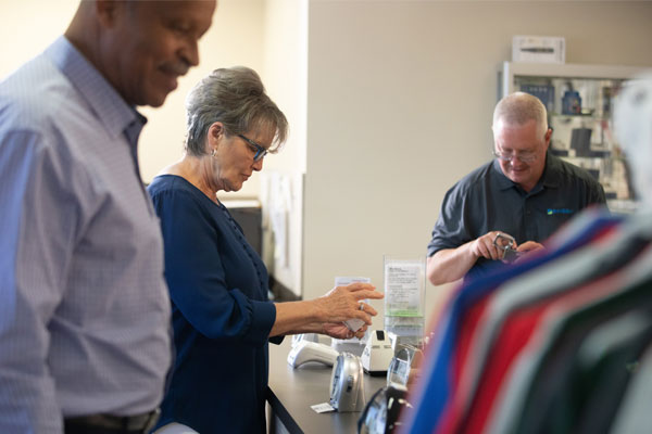 Customers at the Envision Everyday Store look at the variety of visual aids to assist them.